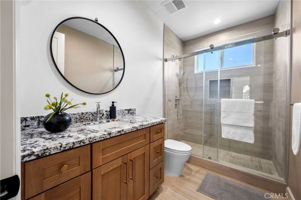 Bathroom, Dual Sink Vanities, Glass Shower, Interior, Recessed Lighting, Wood Texture Flooring