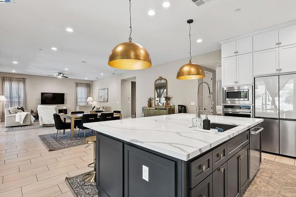Dining room, Fireplace, Interior, Kitchen, Living room, Pendant Lights, Recessed Lighting, Stainless Steel Appliances, Wood Texture Flooring