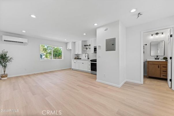 Empty room, Interior, Kitchen, Recessed Lighting, Stainless Steel Appliances, Wood Texture Flooring
