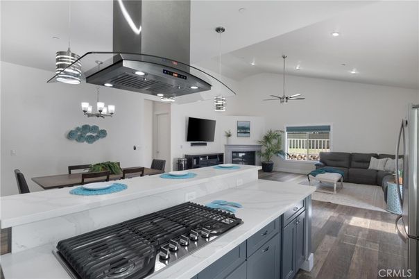 Chandelier, Dining room, Fireplace, Interior, Kitchen, Living room, Pendant Lights, Recessed Lighting, Stainless Steel Appliances, Wood Texture Flooring