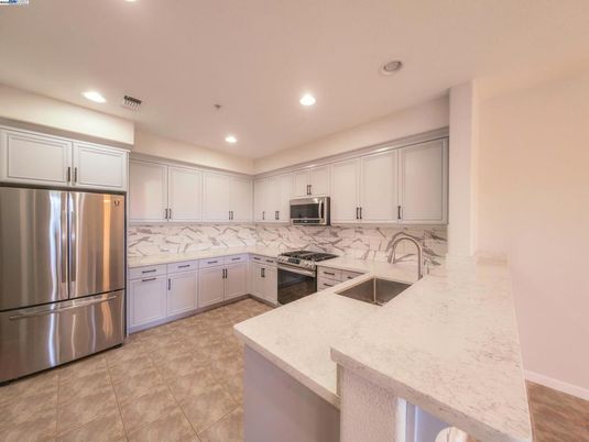 Interior, Kitchen, Marble Walls, Recessed Lighting, Stainless Steel Appliances