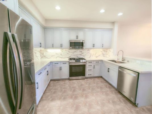 Interior, Kitchen, Marble Walls, Recessed Lighting, Stainless Steel Appliances