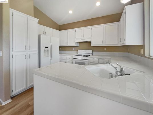 Interior, Kitchen, Recessed Lighting, Tile Countertops, Wood Texture Flooring