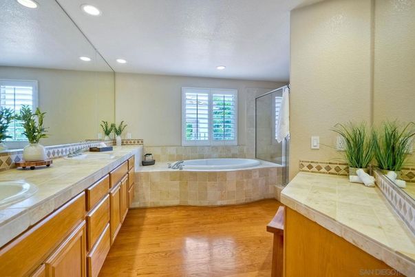 Bathroom, Dual Sink Vanities, Glass Shower, Interior, Recessed Lighting, Tile Countertops, Wood Texture Flooring