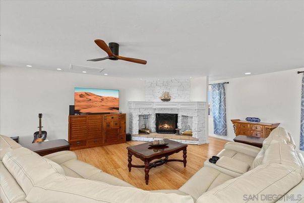 Fireplace, Interior, Living room, Recessed Lighting, Stone Walls, Wood Texture Flooring