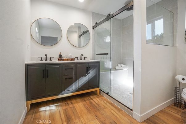 Bathroom, Dual Sink Vanities, Glass Shower, Interior, Recessed Lighting, Wood Texture Flooring