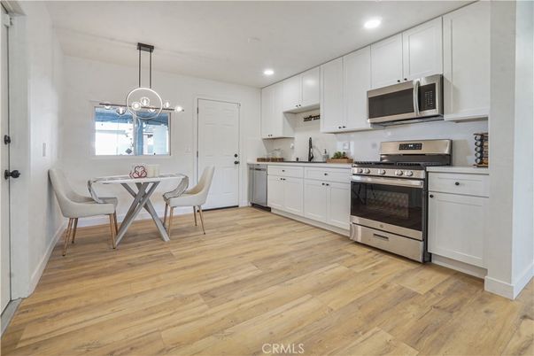 Dining room, Interior, Kitchen, Pendant Lights, Recessed Lighting, Stainless Steel Appliances, Wood Texture Flooring