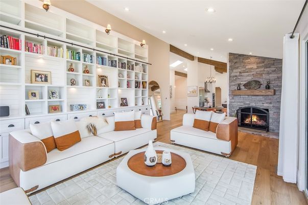 Chandelier, Fireplace, Interior, Living room, Pendant Lights, Recessed Lighting, Stone Walls, Wood Texture Flooring