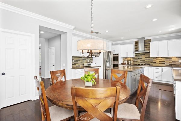 Chandelier, Dining room, Interior, Kitchen, Pendant Lights, Recessed Lighting, Stainless Steel Appliances, Wood Texture Flooring