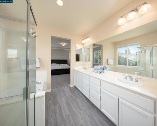 Bathroom, Dual Sink Vanities, Glass Shower, Interior, Recessed Lighting, Wood Texture Flooring