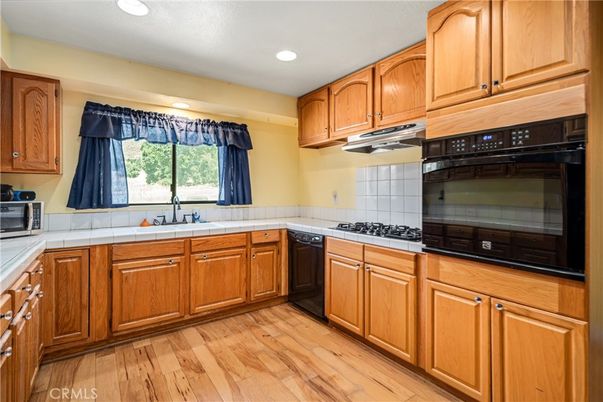 Interior, Kitchen, Recessed Lighting, Tile Countertops, Wood Texture Flooring