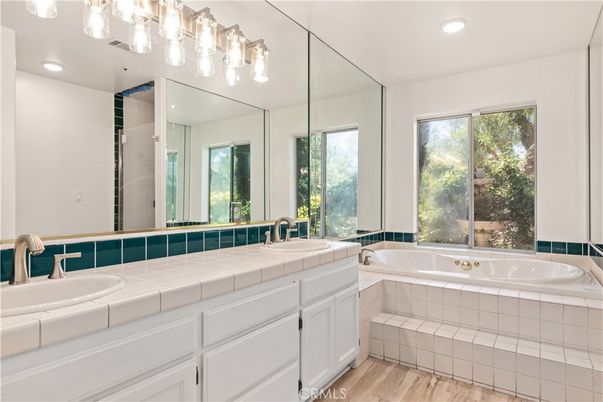 Bathroom, Dual Sink Vanities, Glass Shower, Interior, Recessed Lighting, Tile Countertops, Wood Texture Flooring