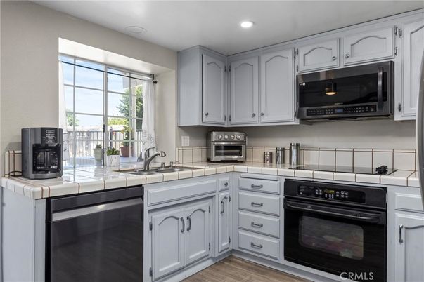 Interior, Kitchen, Recessed Lighting, Stainless Steel Appliances, Tile Countertops, Wood Texture Flooring