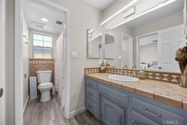 Bathroom, Dual Sink Vanities, Interior, Recessed Lighting, Tile Countertops, Wood Texture Flooring
