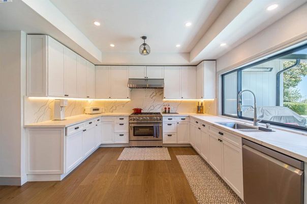 Interior, Kitchen, Marble Walls, Recessed Lighting, Stainless Steel Appliances, Wood Texture Flooring