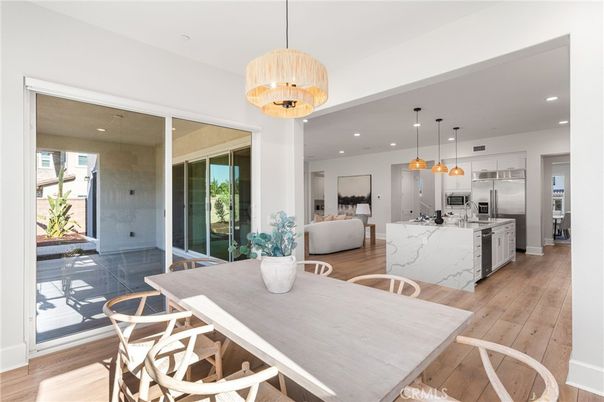 Chandelier, Dining room, Interior, Kitchen, Living room, Pendant Lights, Recessed Lighting, Stainless Steel Appliances, Wood Texture Flooring