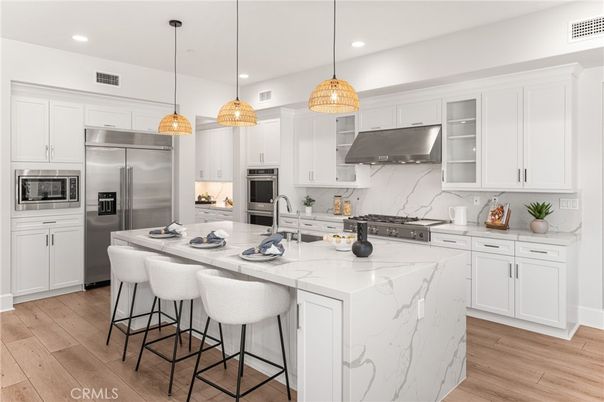 Interior, Kitchen, Marble Walls, Pendant Lights, Recessed Lighting, Stainless Steel Appliances, Wood Texture Flooring