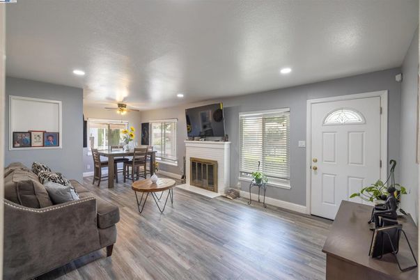 Dining room, Fireplace, Interior, Living room, Recessed Lighting, Wood Texture Flooring