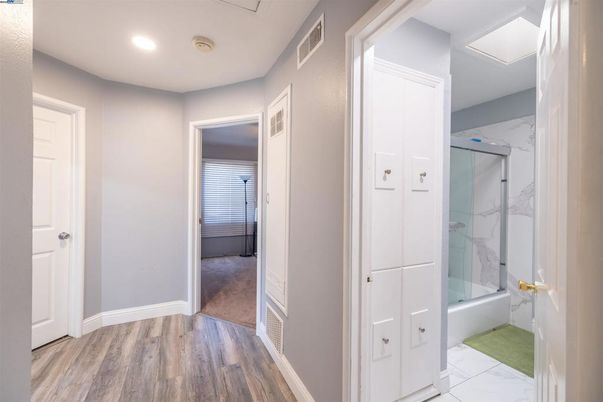 Bathroom, Glass Shower, Interior, Marble Walls, Recessed Lighting, Wood Texture Flooring