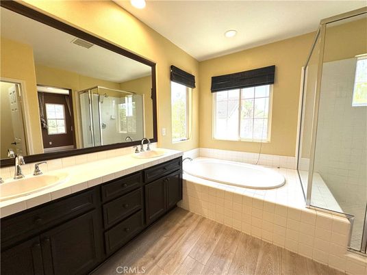 Bathroom, Dual Sink Vanities, Glass Shower, Interior, Recessed Lighting, Tile Countertops, Wood Texture Flooring