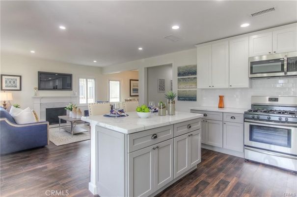 Fireplace, Interior, Kitchen, Living room, Recessed Lighting, Stainless Steel Appliances, Wood Texture Flooring