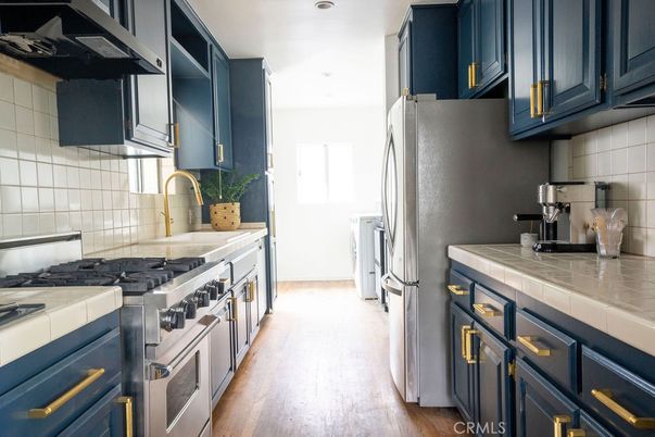 Interior, Kitchen, Recessed Lighting, Stainless Steel Appliances, Tile Countertops, Wood Texture Flooring