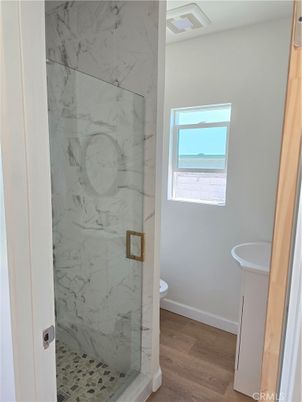 Bathroom, Glass Shower, Interior, Marble Walls, Wood Texture Flooring