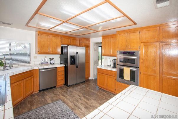 Interior, Kitchen, Stainless Steel Appliances, Tile Countertops, Wood Texture Flooring