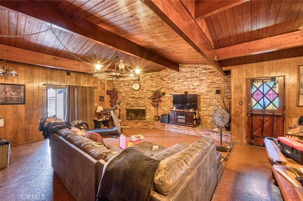 Chandelier, Fireplace, Fitness Equipment, Interior, Living room, Stone Walls, Wooden Beams, Wooden Ceilings, Wooden Walls