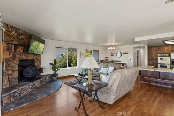 Chandelier, Dining room, Fireplace, Interior, Kitchen, Living room, Stone Walls, Wood Texture Flooring