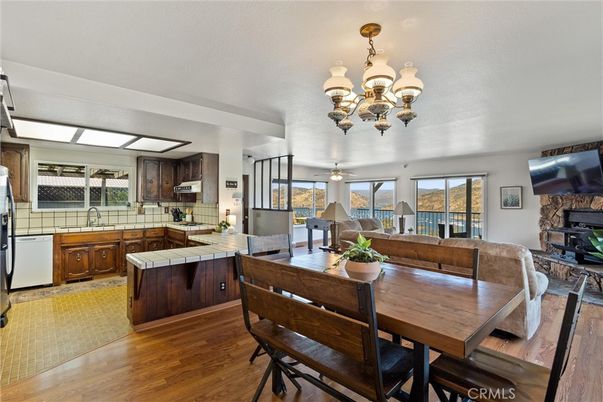 Chandelier, Dining room, Fireplace, Interior, Kitchen, Living room, Tile Countertops, Wood Texture Flooring