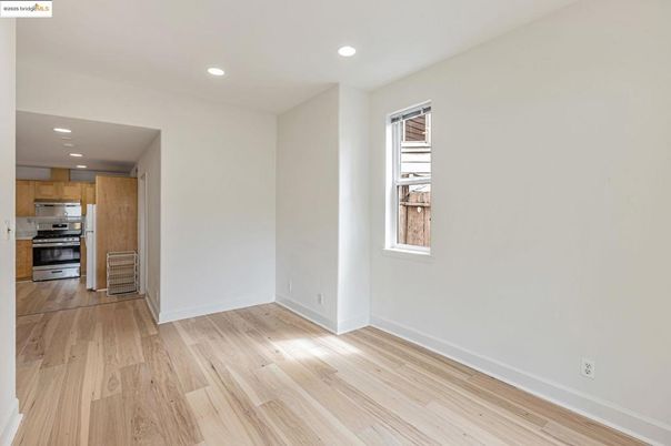 Empty room, Interior, Kitchen, Recessed Lighting, Stainless Steel Appliances, Wood Texture Flooring
