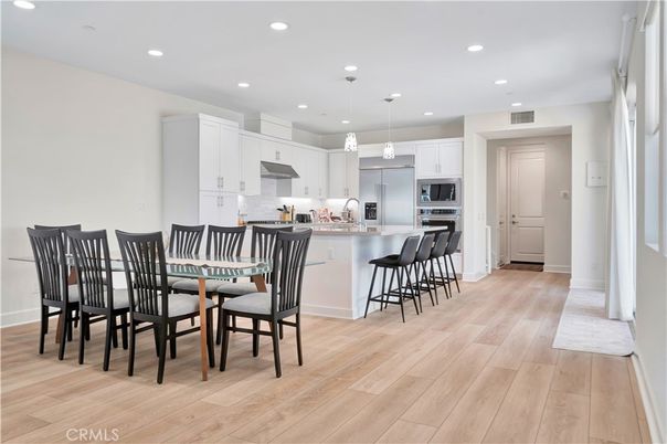 Dining room, Interior, Kitchen, Pendant Lights, Recessed Lighting, Stainless Steel Appliances, Wood Texture Flooring