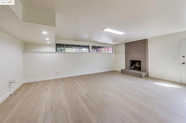 Empty room, Fireplace, Interior, Recessed Lighting, Stone Walls, Wood Texture Flooring