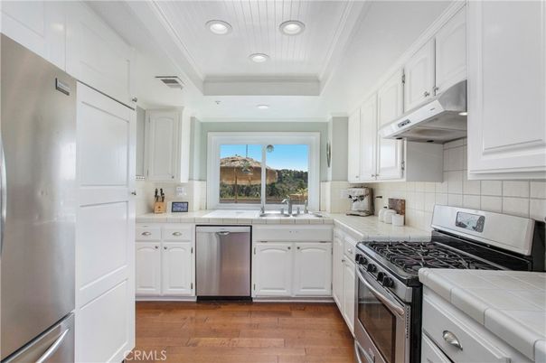 Interior, Kitchen, Recessed Lighting, Stainless Steel Appliances, Tile Countertops, Wood Texture Flooring