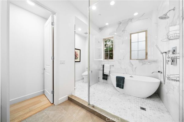Bathroom, Free Standing Baths, Glass Shower, Interior, Marble Walls, Recessed Lighting, Wood Texture Flooring