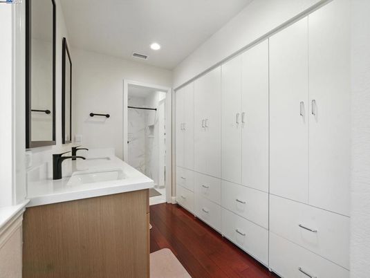 Bathroom, Dual Sink Vanities, Interior, Marble Walls, Recessed Lighting, Wood Texture Flooring