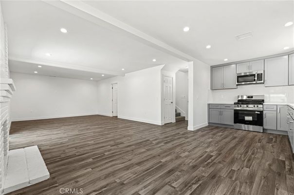 Empty room, Interior, Kitchen, Recessed Lighting, Stainless Steel Appliances, Wood Texture Flooring