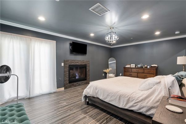 Bedroom, Fireplace, Interior, Pendant Lights, Recessed Lighting, Wood Texture Flooring