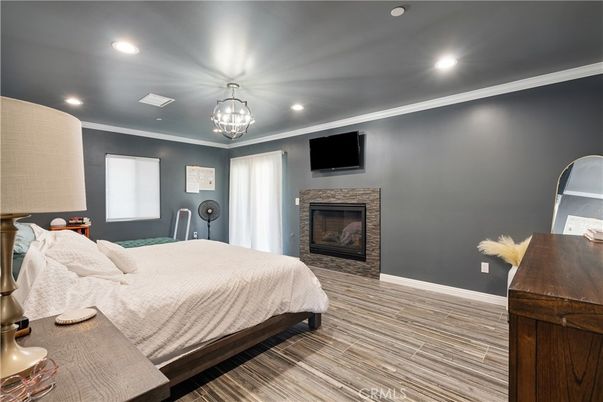 Bedroom, Chandelier, Fireplace, Interior, Recessed Lighting, Wood Texture Flooring