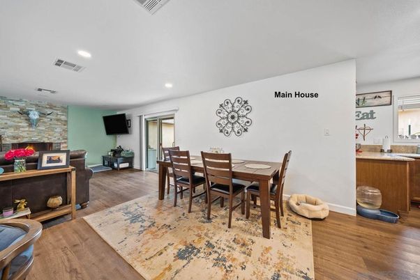 Dining room, Fireplace, Interior, Recessed Lighting, Stone Walls, Wood Texture Flooring