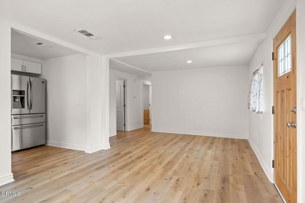 Empty room, Interior, Kitchen, Recessed Lighting, Stainless Steel Appliances, Wood Texture Flooring