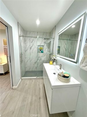 Bathroom, Glass Shower, Interior, Marble Walls, Recessed Lighting, Wood Texture Flooring