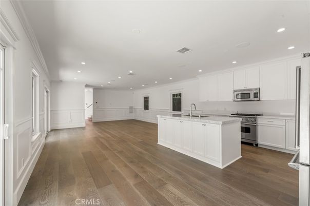 Empty room, Interior, Kitchen, Recessed Lighting, Stainless Steel Appliances, Wood Texture Flooring