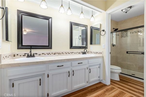 Bathroom, Dual Sink Vanities, Glass Shower, Interior, Tile Countertops, Wood Texture Flooring