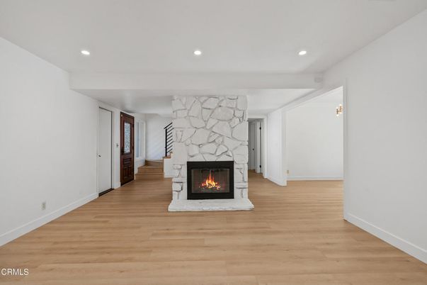 Empty room, Fireplace, Interior, Recessed Lighting, Stone Walls, Wood Texture Flooring