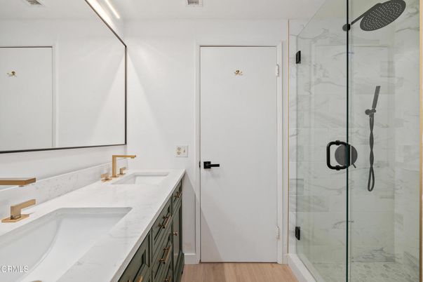 Bathroom, Dual Sink Vanities, Glass Shower, Interior, Marble Walls, Wood Texture Flooring