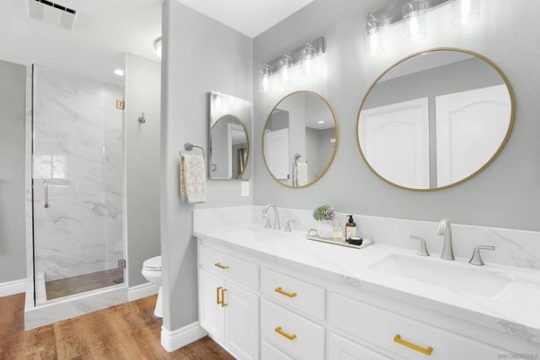 Bathroom, Dual Sink Vanities, Glass Shower, Interior, Marble Walls, Recessed Lighting, Wood Texture Flooring