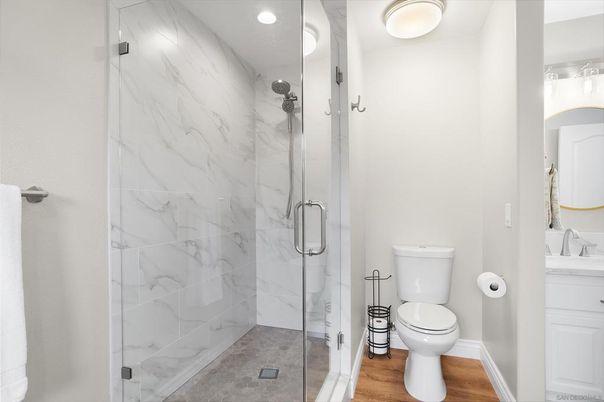 Bathroom, Glass Shower, Interior, Marble Walls, Recessed Lighting, Wood Texture Flooring