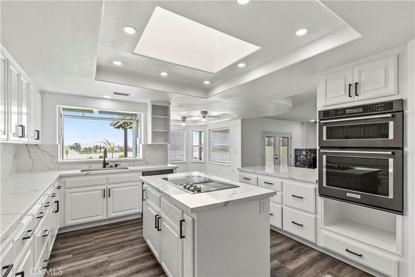 Interior, Kitchen, Marble Walls, Recessed Lighting, Stainless Steel Appliances, Wood Texture Flooring